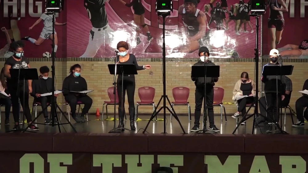 Xtigone staged reading Students standing on a stage